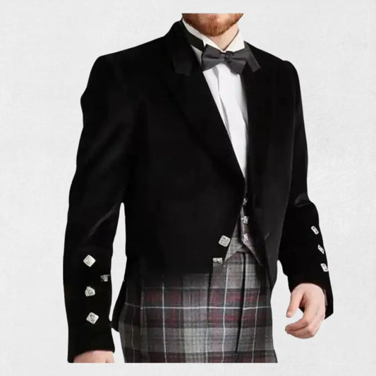 Man wearing black Highland kilt jacket and bow tie on white background, featuring Kiltsstore branding.
